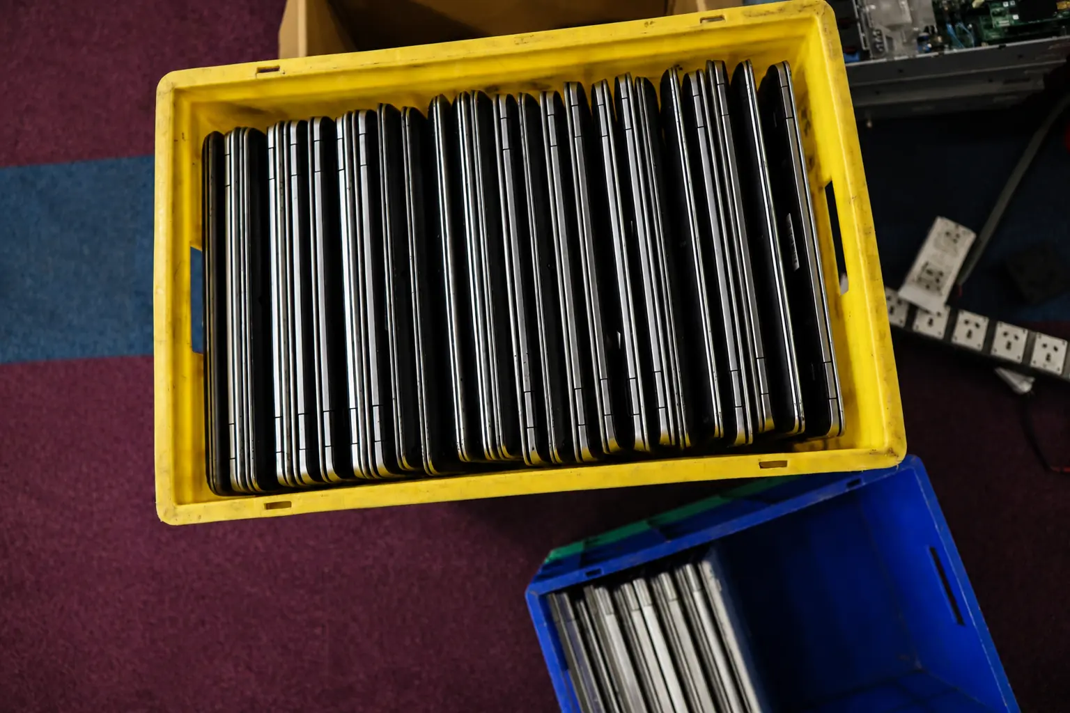 Recovered enterprise laptops collected in bins during secure asset recovery