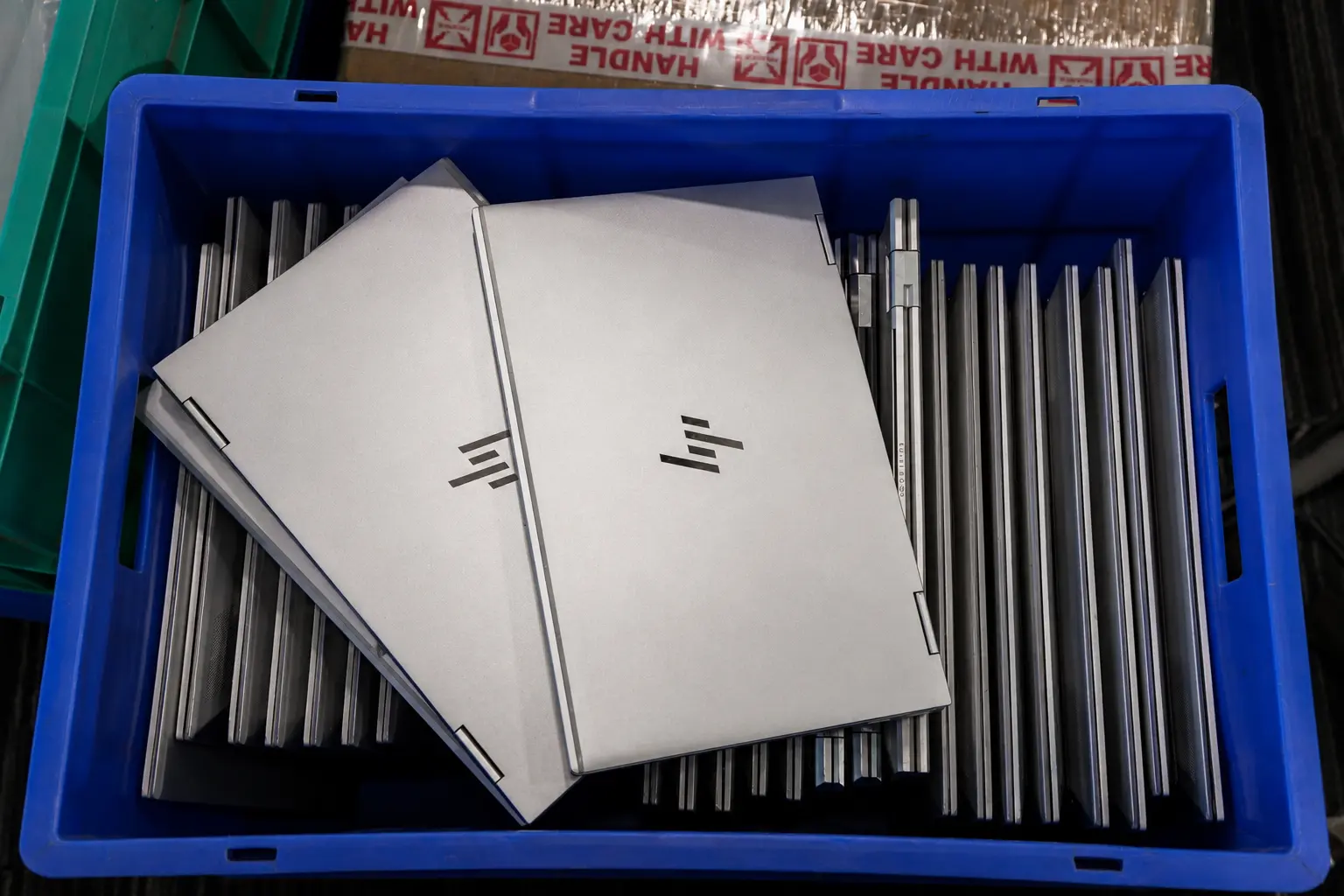 Enterprise laptops handled in bins during device lifecycle execution
