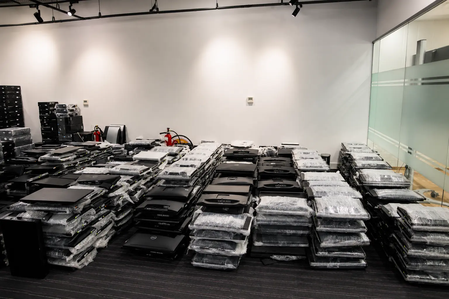 Enterprise laptops staged in volume ahead of a workplace deployment